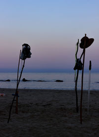 Lifeguard hut on beach against sky during sunset