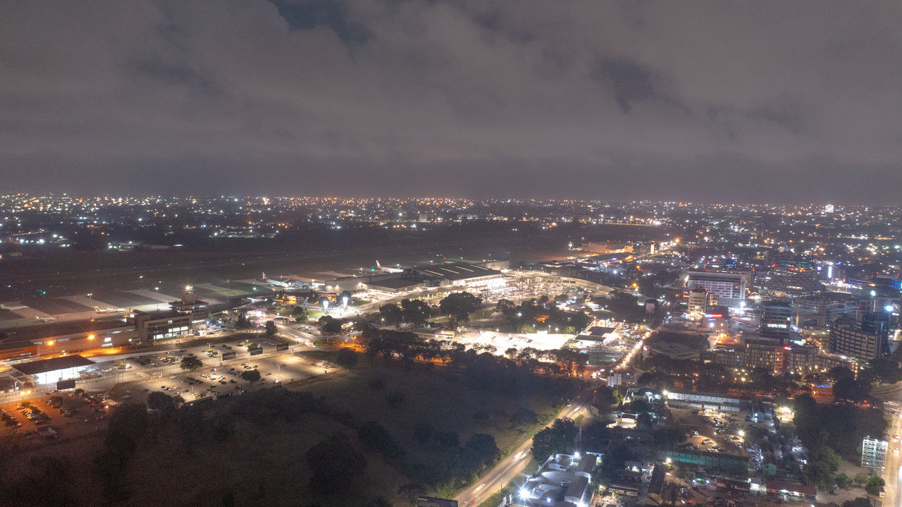 HIGH ANGLE VIEW OF ILLUMINATED BUILDINGS AT NIGHT