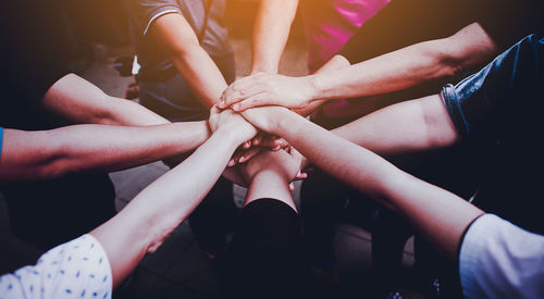 High angle view of friends stacking hands