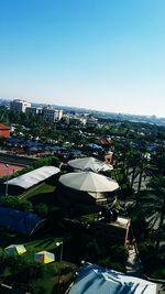 High angle view of buildings against clear blue sky