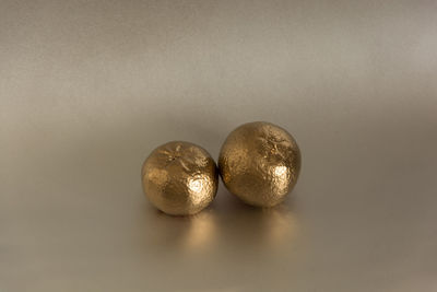 Close-up of balls on table against white background