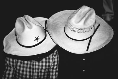 Close-up of people wearing cowboy hats 