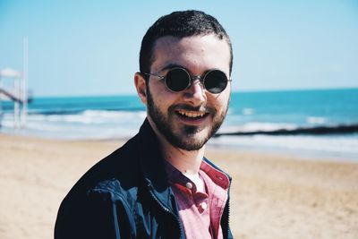Close-up portrait of bearded young man wearing sunglasses during sunny day