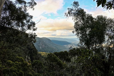 Scenic view of mountains against cloudy sky