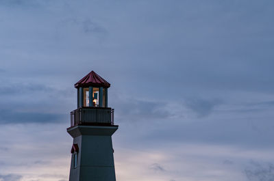 Lighthouse against sky at dusk