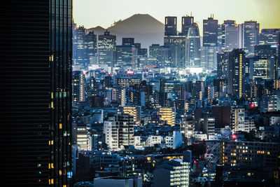 Aerial view of illuminated buildings in city at night