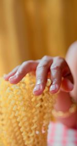 A woman is touching pasta