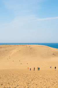 Scenic view of beach against blue sky