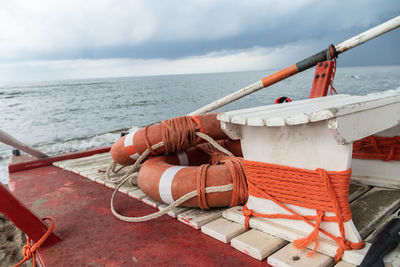 Orange lifebuoys with ropes on a rescue rowing catamaran