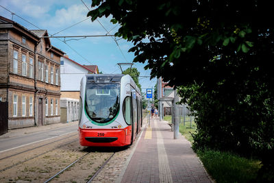 Train on street in city against sky