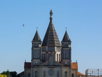 Low angle view of building against clear blue sky
