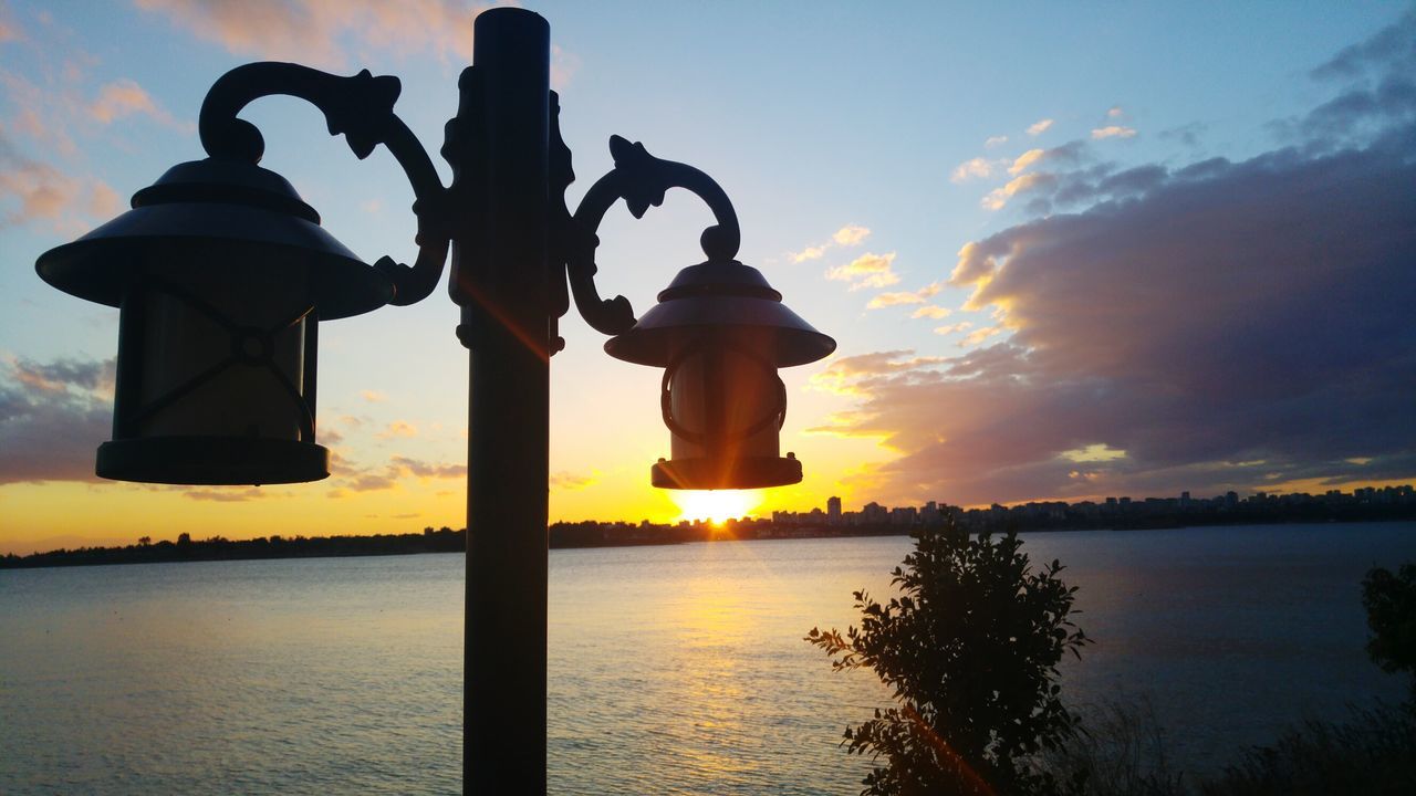 sunset, water, sky, silhouette, sea, tranquility, scenics, tranquil scene, orange color, beauty in nature, reflection, nature, horizon over water, sun, cloud - sky, idyllic, sculpture, human representation, waterfront, cloud