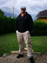 Man standing on stones against sky