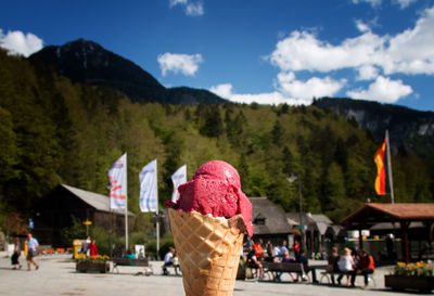 Close-up of ice cream against mountains