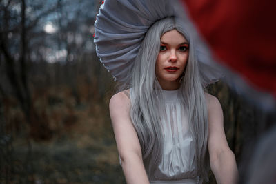 Portrait of a beautiful young woman standing outdoors