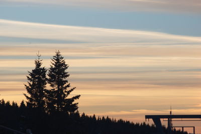 Silhouette tree on landscape against sky during sunset