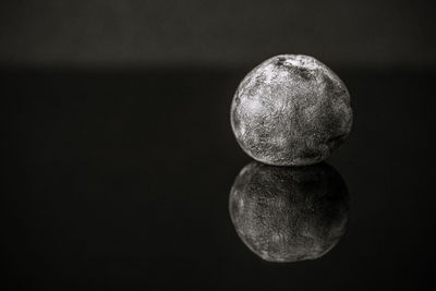 Close-up of crystal ball against black background