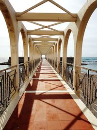 Bridge over sea against sky