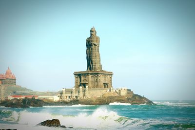 Thiruvalluvar statue in sea against clear sky