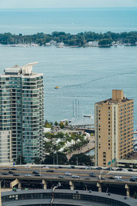 High angle view of buildings by sea against sky