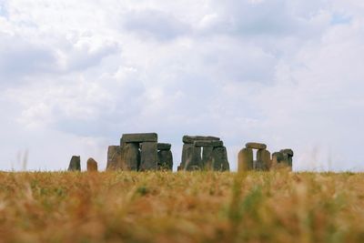 Built structure on field against sky