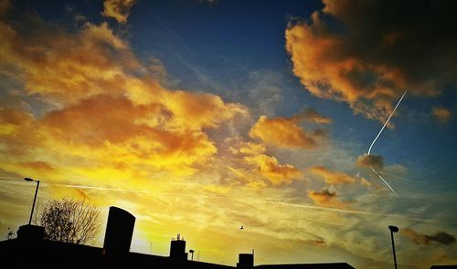 Low angle view of silhouette dramatic sky during sunset