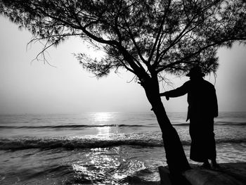 Man standing by sea against sky