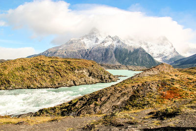 Scenic view of sea and mountains against sky