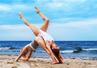 Low angle view of young woman on beach