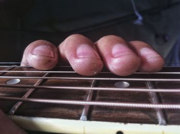Close-up of person holding guitar