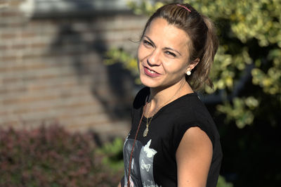 Portrait of smiling woman standing outdoors