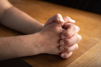 Low section of man with hand on floor