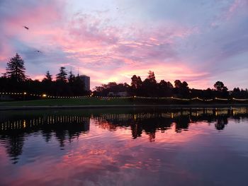 Scenic view of lake against sky at sunset