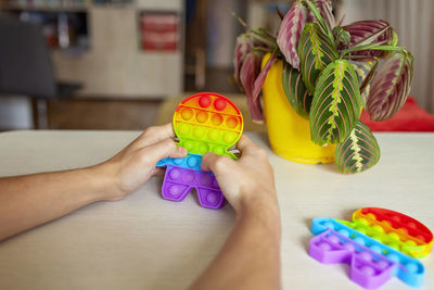 Midsection of woman holding toy at home