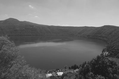 Scenic view of river and mountains against sky