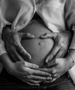 Midsection of woman touching baby