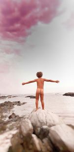 Rear view of man standing on beach