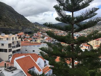 Houses in town against sky