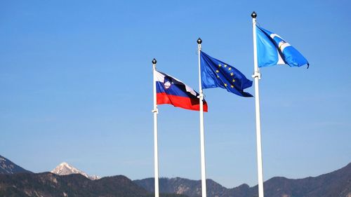 Low angle view of flag against blue sky