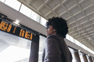 Low angle view of young woman looking at camera