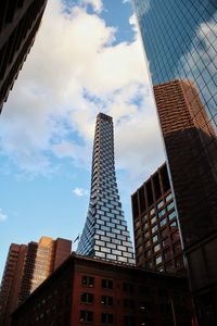 Low angle view of buildings against cloudy sky