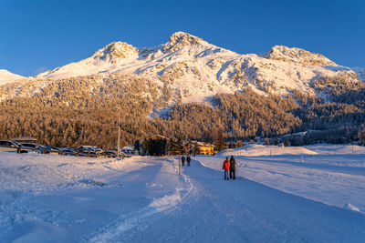 View of beautiful snow mountains near lake silvaplana in switzerland during a cold winter sunset