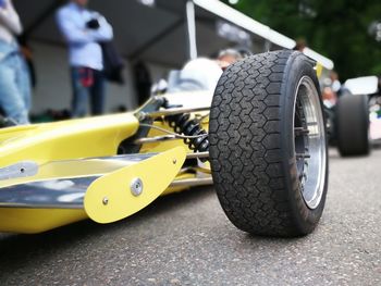 Close-up of low section of car on road