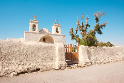 Low angle view of historic building against clear blue sky