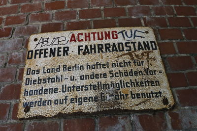 Close-up of information sign on wall