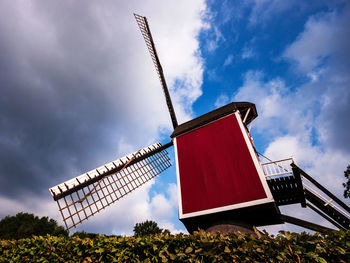 Low angle view of traditional windmill against sky