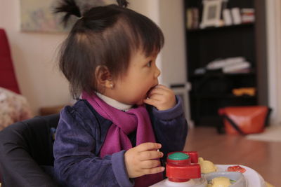 Cute girl sitting in baby walker