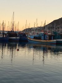 Boats moored at harbor