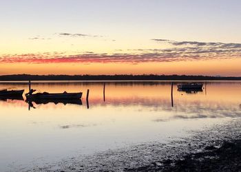 Scenic view of lake against sky during sunset