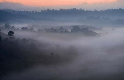 Scenic view of mountains against sky at sunset